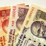 Close-up image of Indian rupee banknotes in various denominations, showcasing currency design.